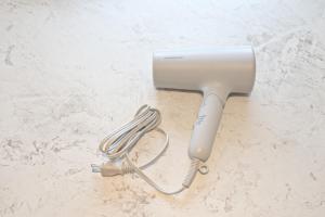 a hair dryer sitting on a counter with a whisk at ゲストハウス夢宿 in Osaka