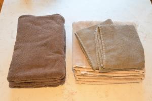 two stacks of towels sitting on a table at ゲストハウス夢宿 in Osaka +27 photos
