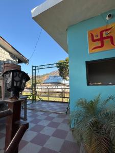 a room with a blue wall and a tv on a wall at Rudraksh Hotel and restaurant in Amgarhi