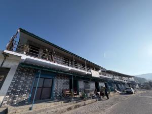 a building with a balcony on the side of a street at Rudraksh Hotel and restaurant in Amgarhi