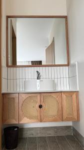 a bathroom with a sink and a mirror at Moon Hotel Buôn Hồ in Buôn Tring