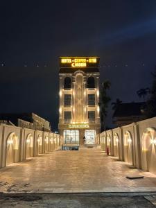 a building with a sign on the side of it at night at Moon Hotel Buôn Hồ in Buôn Tring