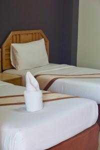 a group of three beds in a room at PK Garden Hotel in Ban Chiang Wang +6 photos