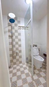 a bathroom with a shower and a toilet in it at North House in Ấp Bình Trung +22 photos