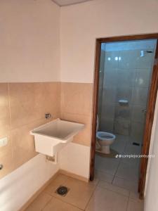 a bathroom with a sink and a toilet at Complejo Cambyreta in Encarnación