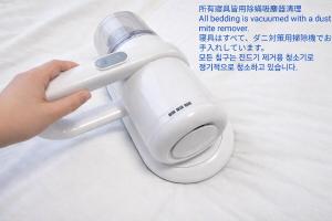 a person holding a nintendo wii remote control at Wstay in Ozu +17 photos