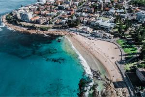an aerial view of a beach with buildings and the ocean at Guesthouse Nature Escape Sleeps up to 6 in Heathcote
