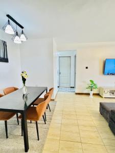a living room with a table and chairs at Palazzo serenity in Ongata Rongai 