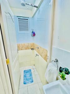 a small bathroom with a sink and a shower at Palazzo serenity in Ongata Rongai  +39 photos