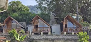a group of cottages on a hill with trees at Teras Danu in Bedugul +2 photos