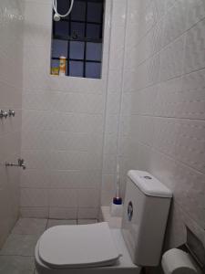 a white bathroom with a toilet and a window at Machakos Town Studios in Machakos +11 photos