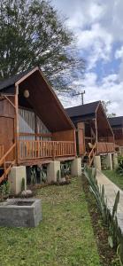 a large wooden house with a large deck at Teras Danu in Bedugul