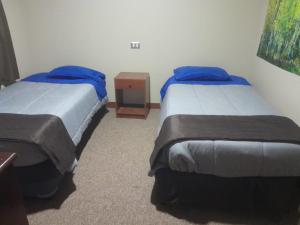two twin beds in a room with at El valle 2 in Copiapó