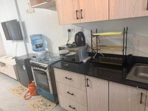 a kitchen with a stove and a counter top at Bliss Homes in Nairobi +2 photos