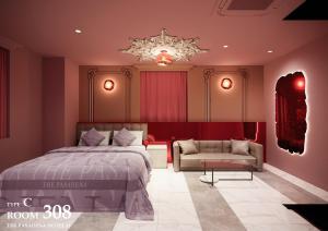 a bedroom with a bed and a couch and a chandelier at hotel the pasadena 11 funabashi in Funabashi +16 photos