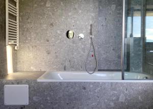 a bath tub with a shower in a bathroom at Terrazza sull Argentario in Ansedónia +63 photos