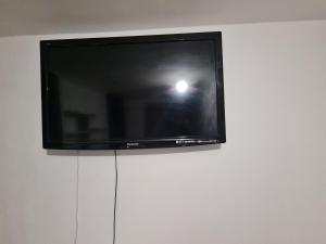 a flat screen tv sitting on top of a white wall at Guesthouse 3 in Tilbury
