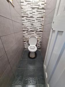 a small bathroom with a toilet in a stall at Guesthouse 3 in Tilbury