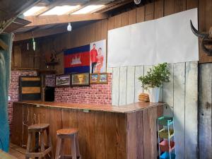 a bar in a restaurant with two stools at Happy Elephant Bungalows in Senmonorom +20 photos