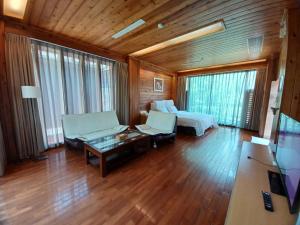 a large living room with a bed and a couch at Pei Kong Creek Resort in Guoxing