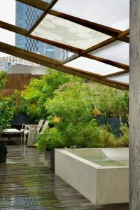 a building with a patio with chairs and trees at AET & o3 HOTEL in Tokyo