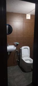 a bathroom with a toilet and a sink at Casa Shanti in Kannur