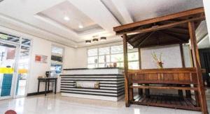 a large room with a fireplace in a building at Quezon Premier Hotel - Candelaria in Candelaria