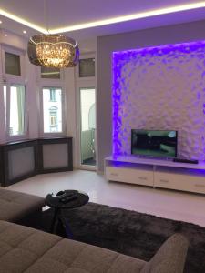 A television and/or entertainment centre at Synagogue Gozsdu Private Apartments