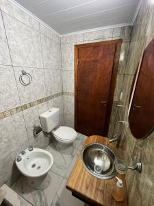 a bathroom with a toilet and a sink at Bahía de cimarrones in Dolores +38 photos