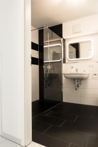 a bathroom with a shower and a sink at Design Apartment Metzingen in Metzingen