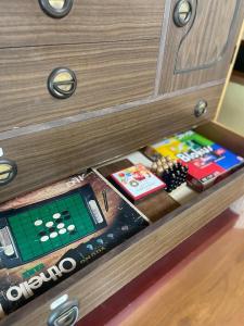 a drawer with a game system in a cabinet at 自宅民泊The 34Sassysサッシーズ萩市佐々並 in Yamaguchi