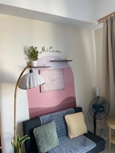 a living room with a couch and a calendar on the wall at Mactan Plains condo unit in Punta Engaño