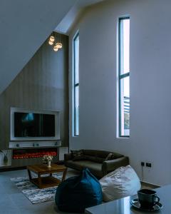 a living room with a couch and a tv at Ubuntu Residence in Ruhengeri