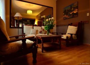 a living room with a couch and a table with flowers at Hotel Santa Eulalia II in Miramar