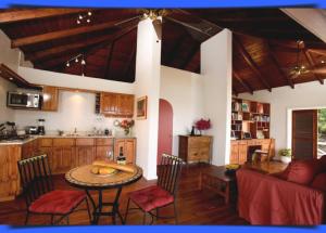 a kitchen and living room with a table and chairs at Blue Moon Antigua in English Harbour Town