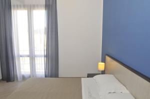 a bedroom with a bed and a window at B&B Cous Cous People in San Vito lo Capo