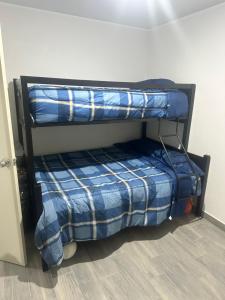 two bunk beds in a room next to a wall at La Casa de Coco in Oacalco