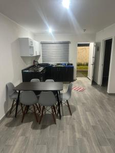a kitchen and dining room with a table and chairs at La Casa de Coco in Oacalco