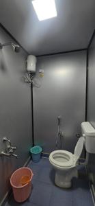 a bathroom with a toilet and a shower at Nishatana Farm Stay in Bangalore +11 photos