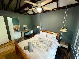 a bedroom with a bed and a ceiling fan at Elephant loft in Stormsrivier