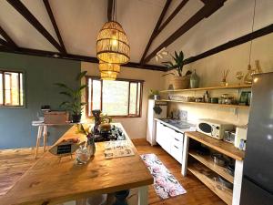 a kitchen with a wooden table in a room at Elephant loft in Stormsrivier