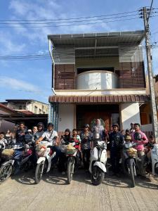 a group of people on motorcycles parked in front of a building at The Warm House in Ban Komo Sip Paet