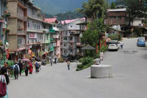 a group of people walking down a street with buildings at K2k homestsy in Rhenok