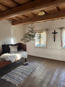 a bedroom with a bed and a cross on the wall at chalupa Hajan in Valašská Polanka