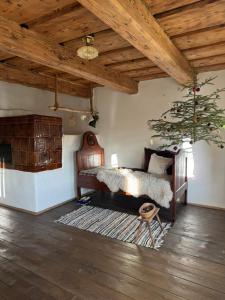 a bedroom with a bed and a christmas tree at chalupa Hajan in Valašská Polanka