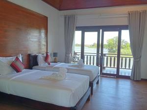 En eller flere senge i et værelse på Paradise Resort