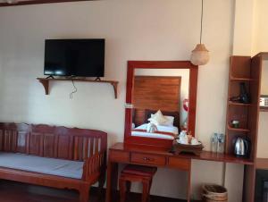 a bedroom with a mirror and a bed and a desk at Paradise resort, Don Det river view in Don Det