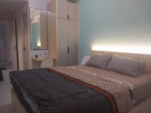 a bedroom with a bed with a dresser and a mirror at Asikin Room in Bulanbulan