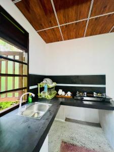 a kitchen with a sink and a counter top at Sea Paradise Hidden Villa in Tangalle