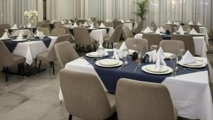 a room filled with tables and chairs with plates and napkins at Golden Gate Hotel Hawassa in Āwasa